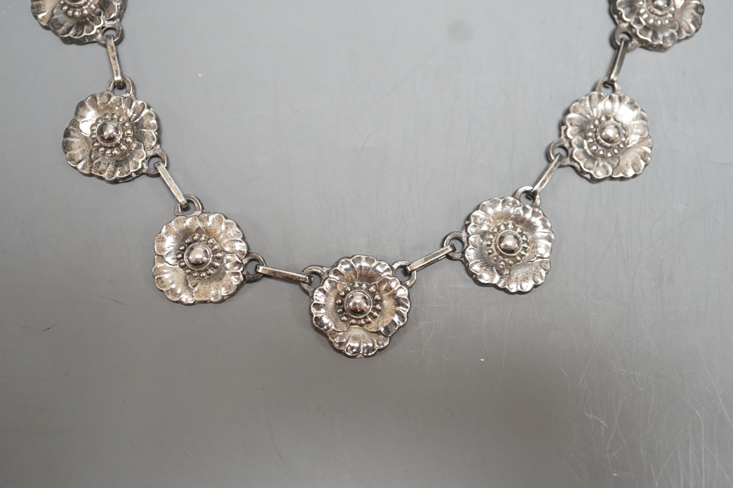 A Georg Jensen sterling flowerhead fringe necklace, no. 30A, 65cm and a pair of matching earrings, no.49